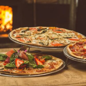 Three delicious pizzas showcasing how to hire a pizza oven